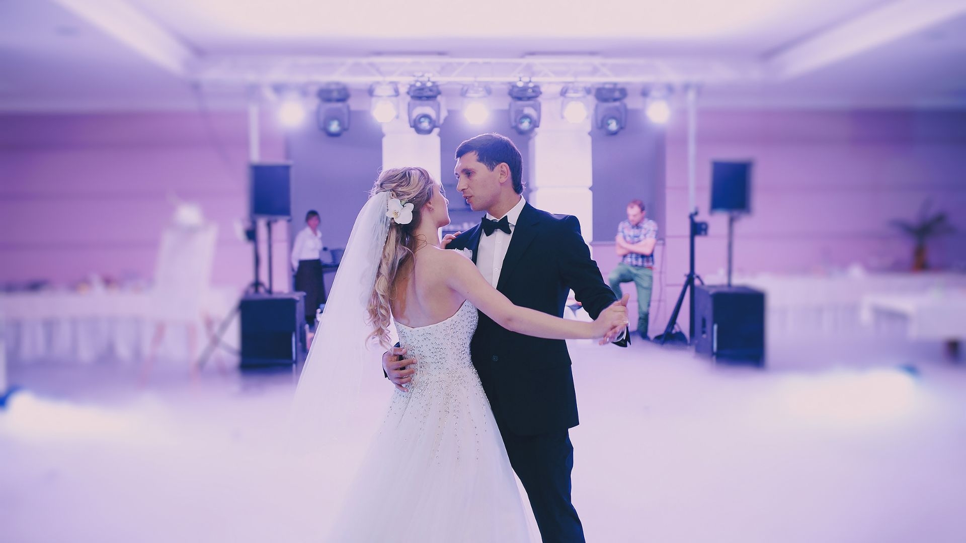 Are there specific adhesives recommended for securing a dance floor wrap in place?