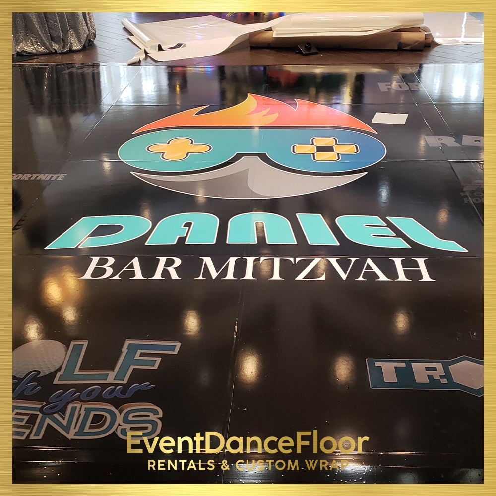 How can one ensure that the surface is completely clean and ready for the installation of dance floor wraps?