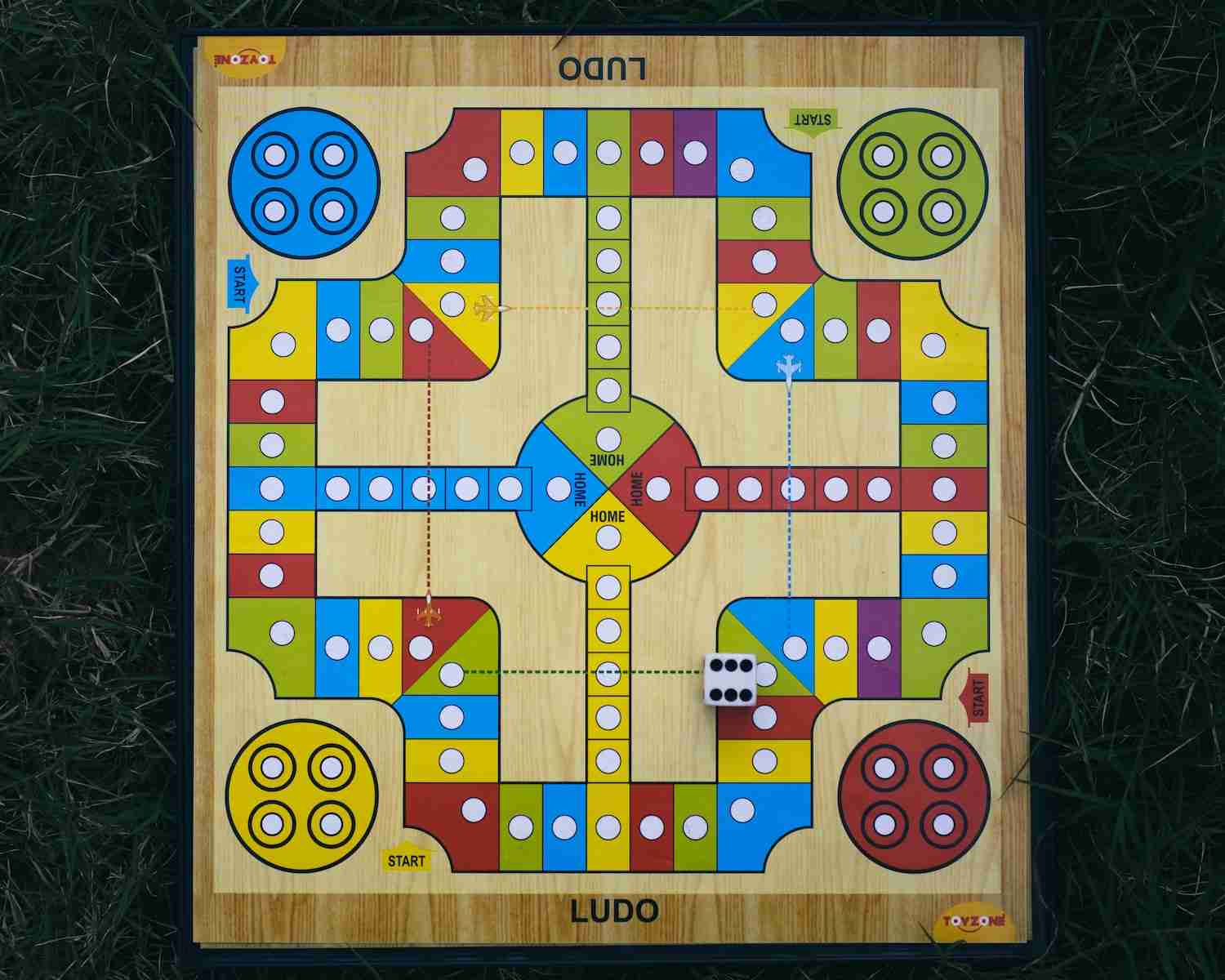 a wooden board game on the grass