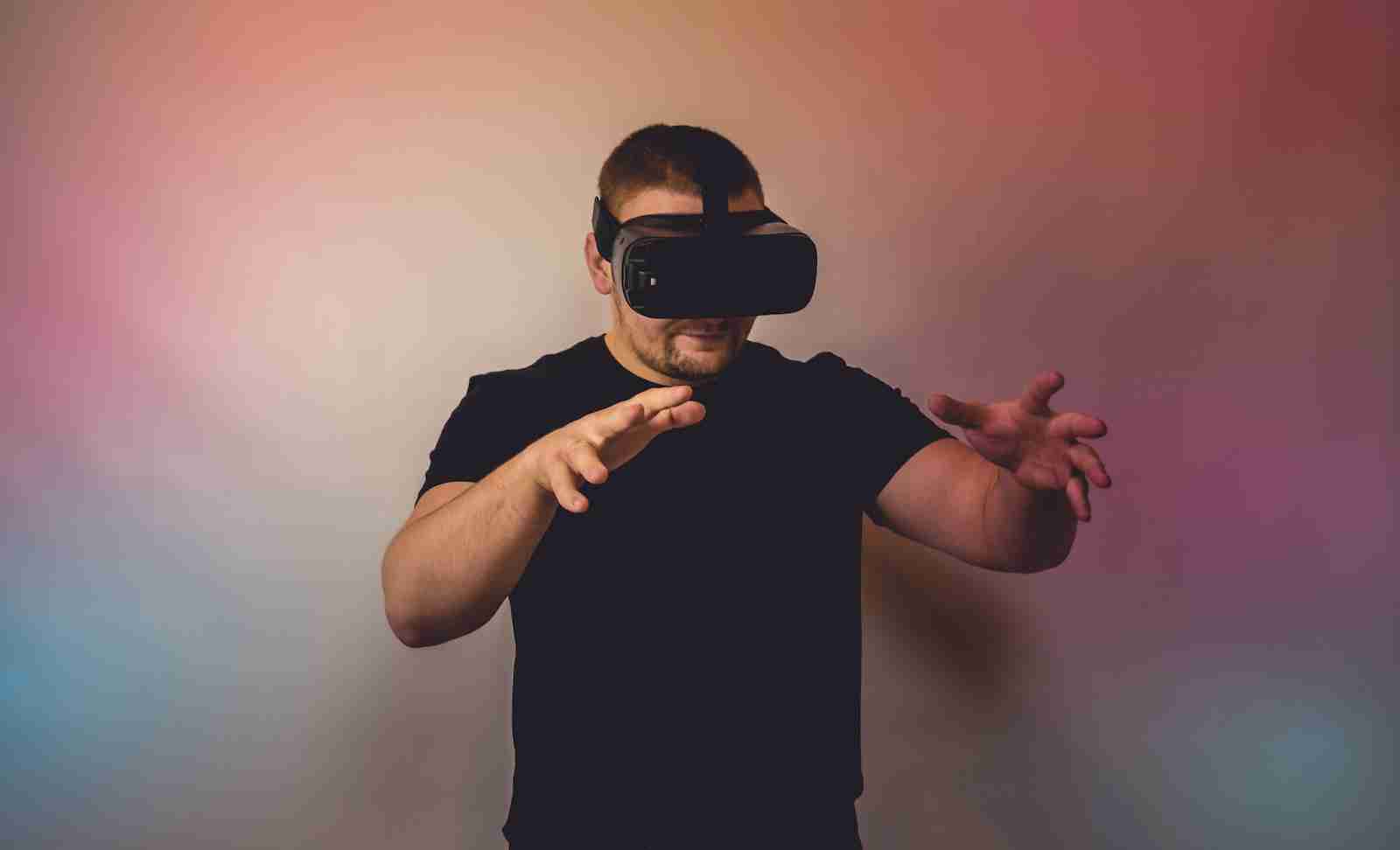 a man in a black shirt is using a virtual device