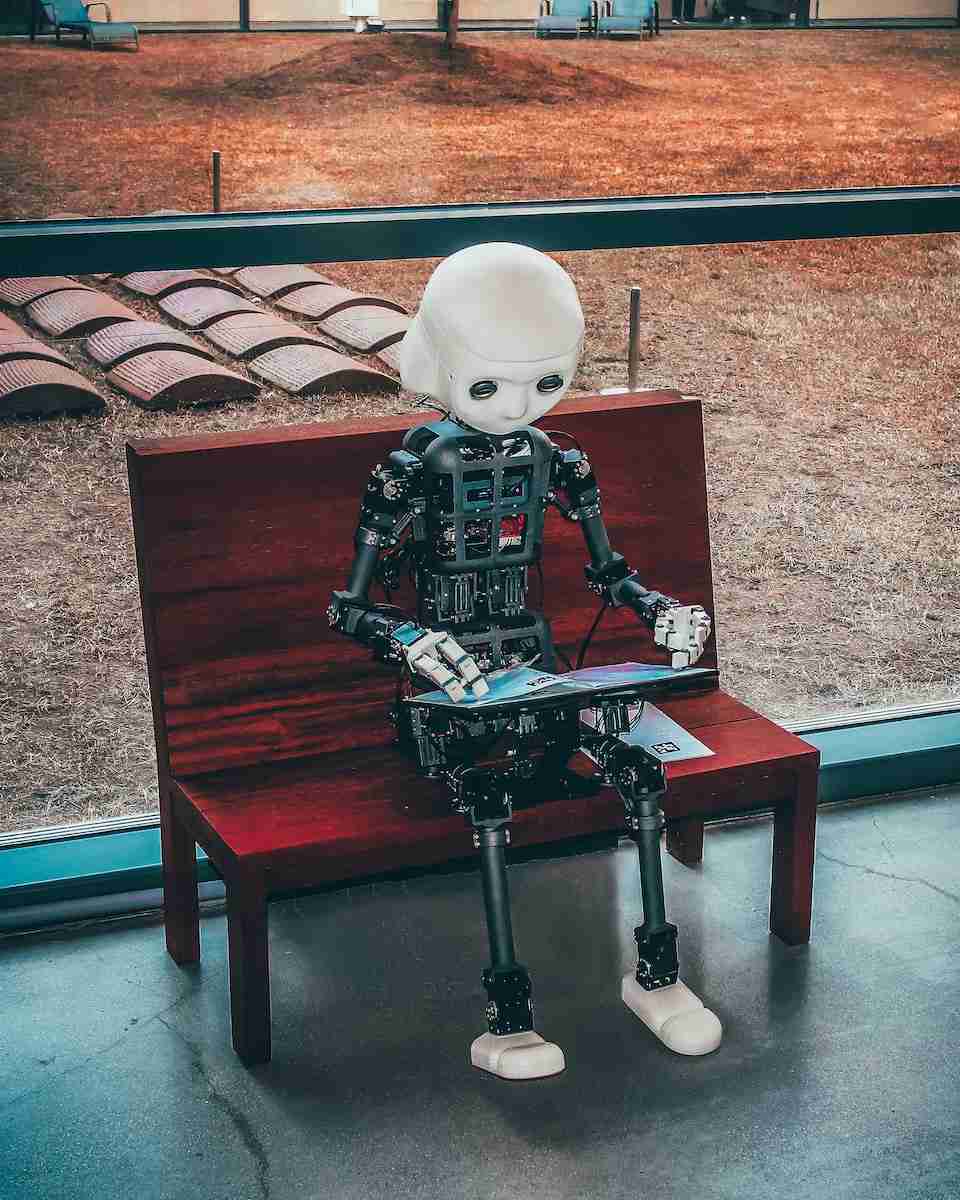 Photo by Andrea De Santis black and white robot toy on red wooden table