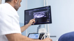 Doctor Consults Patient During Testicular Ultrasound Scan