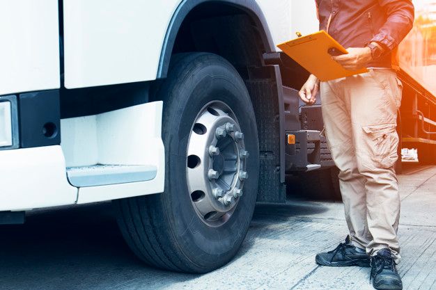 truck-driver-holding-clipboard-with-cheking-safety-tire-truck_36860-9