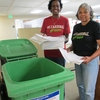 Two Stanford staff members take the extra step of bringing their paper waste to the recycling bin in the hallway.