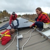 College of the Atlantic students working with the school's Community Energy Center install photovoltaic panels on the roof of a nearby business. The owner of the business decided to go solar after receiving a free energy audit from the CEC which spelled out financing mechanisms and other details. Many COA students who work with the Thoreau Environmental Leaders Initiative also work with the CEC, and through COA courses, to gain an experiential understanding of renewable energy issues.