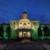 The McCall-MacBain Arts Building is lit with a green light to celebrate McGill's achievement of a Platinum STARS rating.