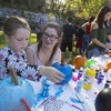 Local residents decorate pumpkins at Binghamton University's Fall Festival, held at Walnut Street Park. This event is part of the Neighborhood Heritage and Sustainability project supported by Binghamton University's Sustainable Communities Transdisciplinary Area of Excellence and the Division of Student Affairs.