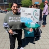 A student leader at Portland Community College shows off the sign they made for the youth climate rally during PCC's annual Eco-social Justice Day event.