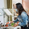 Pacific student selecting from the Farm to Fork salad bar.