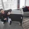 Doctoral student Matheus Fernandes tests out healthier chairs and furniture inside Peabody Terrace. These chairs, used by Harvard University Housing, feature chemical flame retardant-free materials. In 2015, Harvard became the first university to sign a national pledge stating a preference for purchasing furniture manufactured without the use of toxic flame retardants. Peabody Terrace was the first project of its size to implement the new pledge on campus.