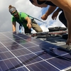 Bates Students install solar panels on the roof of their coastal research facility