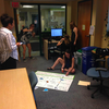 Each week, the Tufts University Eco-Reps team up to create resources for their Meatless Monday dinner. Here, they are working on a poster that highlights the environmental impact of various types of protein including red meat, poultry, fish, and tofu.