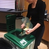 An IUPUI employee uses a compost bin