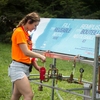 A student fills up a water bottle using a water cart purchased during the Refill McGill campaign