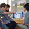 Ying Hua, Assistant Professor in DEA, discussing energy dashboard research with her two student assistants.