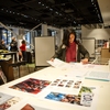 A Concordia University staff member reviews content during a climate change poster installation at the university.