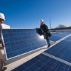 Contractors install solar panels on the School of International Service at American University in Washington, DC.