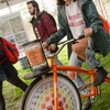 UMass Amherst student pedaling the bike-powered blender to make smoothies at the Earth Day Festival.