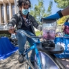 4th year neurobiology major Eiad Mohamed blends a fruit smoothie with a bike blender at SUSTAINIVAL, the campus sustainability fair, hosted by the UCI Sustainability Resource Center.