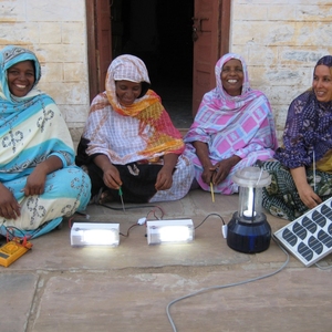 Four participants of the Barefoot College display their projects.