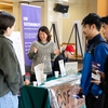 Kort Maeda of the University of Washington's Campus Sustainability Fund (CSF) tables at a UW 2023 Earth Day Fair.