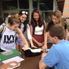 Lehigh students interact with animals, including a red-tailed hawk, skunk, turtle, and snake from Wildlands Conservancy, during the Earth Day Fair on April 22.