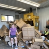 UMN Morris student recycling cardboard at campus recycling center