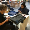 Penn State Green Teams members Barbara Taylor and Ashli Baker are making reusable cloth bags from cotton t-shirts at an event during Penn State’s multi-week Earth Day(s) 2017 celebration.