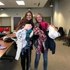 (L-R) Office of Sustainability intern Katie Piel and Outreach Director for the Associated Students of Madison (ASM) Sustainability Committee, Madalynne Bridge, hold piles of clothing donated for the ASM Clothing Swap, held during Earth Week on the UW-Madison Campus.