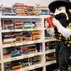 Appalachian State University mascot Yosef peruses the book selection in a promotional photo for the Sustainability Bookstore. 