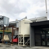 Wood waste to energy system photo, with chipper enclosure frame erected by ironworker students