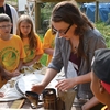 Western Michigan University student demonstrating beekeeping to local elementary school