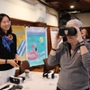 Former Administrator of the EPA, Gina McCarthy, trys out a virtual reality project entitled "Beach," created by Harvard Graduate School of Design students at the Harvard Sustainability Showcase. "Beach" is an interactive experience which allows the viewer to see how different parts of Harvard's campus will be affected by sea level rise.