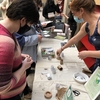Showing visitors how to make the paper-pots