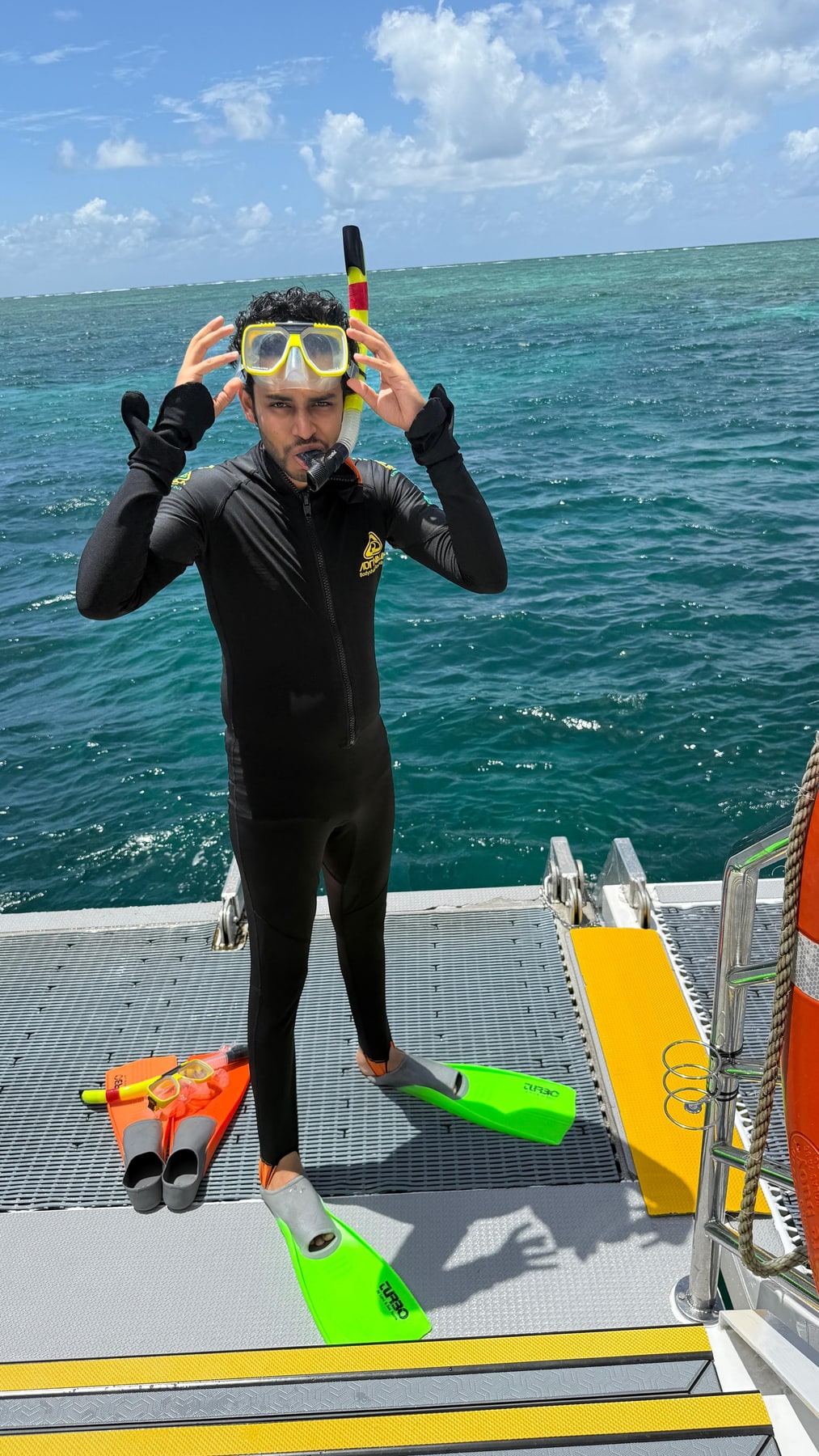 a wetsuit on the reef boat, pretending to be brave 🤿