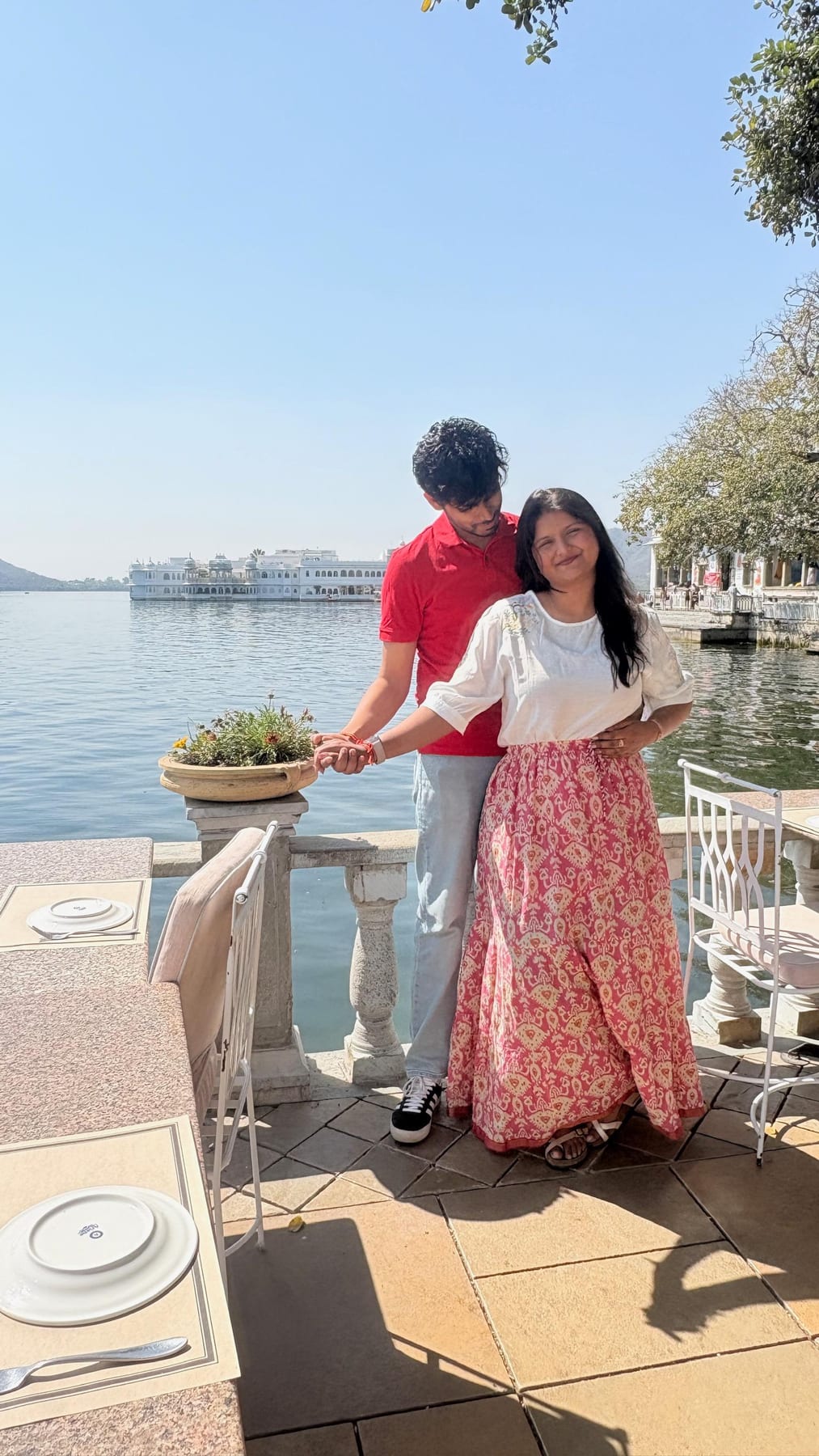 holding hands by the lake, the palace behind us