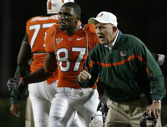 Miami head coach Larry Coker, right, and Khalil Jones (87) celebrate after Javarris James (not pictured) scored a two-yard go ahead touchdown run...