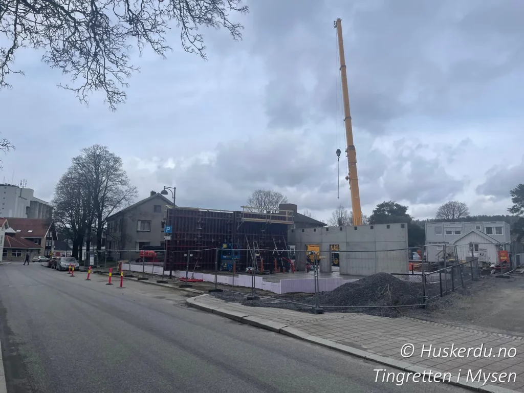 🏗️🔨 Tidlig fase av byggingen av tingretten 🔨🏗️ På dette bildet ser vi en tidlig fase av byggingen av Follo og Nordre Østfold tingrett i Mysen. Kranen er på plass, og de første betongveggene begynner å reise seg. Arbeidet med å skape et moderne og funksjonelt tinghus var godt i gang, med fokus på universell utforming og tilgjengelighet for publikum. Denne rettsbygningen skulle bli et viktig juridisk senter for regionen og et symbol på rettssikkerhet i Indre Østfold. Foto: Huskerdu.no http://huskerdu.no follo-nordre-ostfold-tingrett-rettssted-mysen-kran Follo og Nordre Østfold tingrett – Tidlig byggefase i Mysen Mysen, Østfold tingrett, Follo tingrett, Indre Østfold tingrett, domstol Mysen, tingrettsbygning, Follo og Nordre Østfold tinghus, Mysen domstol, domstol Østfold, kran, bygging tingrett