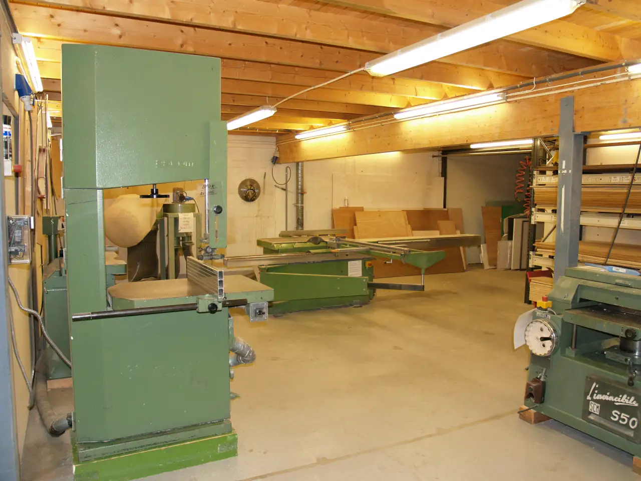Snekkerverkstedet under mesaninen hos Norild i Askim, med rammesag og maskiner for produksjon av trekonstruksjoner.