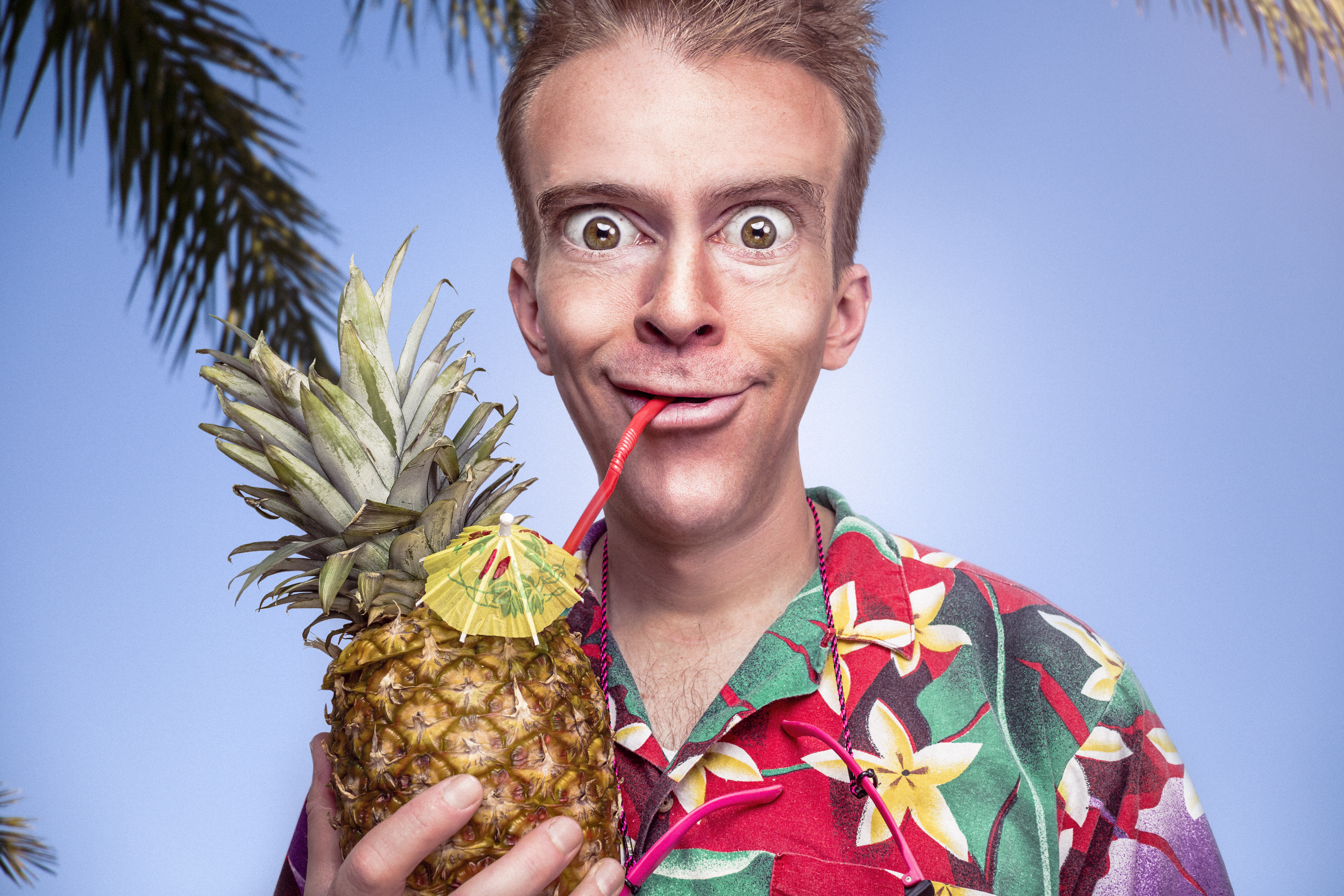 odd man drinking from a pineapple