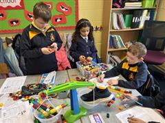 2nd class exploring Capacity, Area and Weight in their Maths stations.