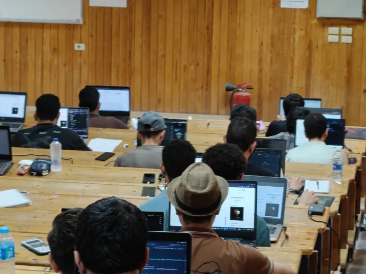 Students solving problems on laptops during a training contest