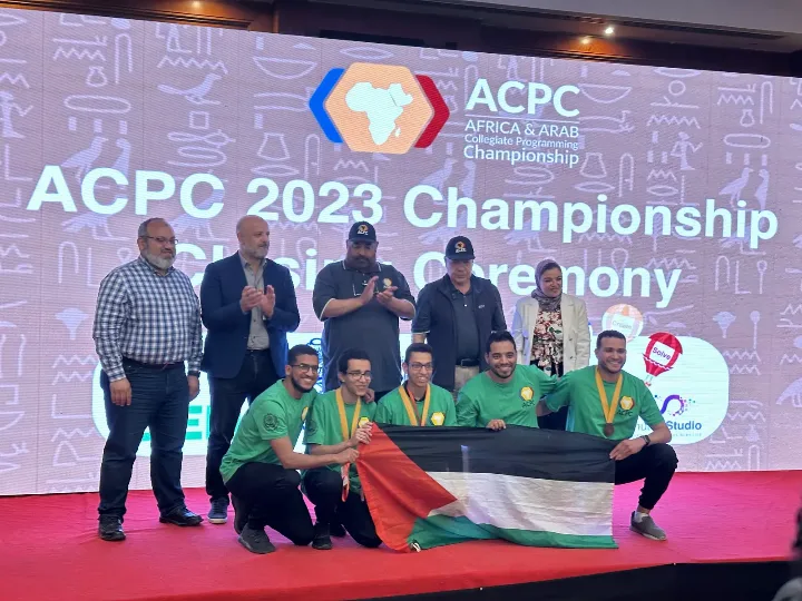 Assiut teams on the ACPC 2023 championship stage with the Palestinian flag