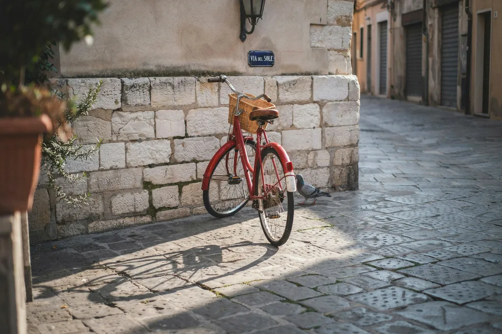 a red bicycle in a cobblestone plaza