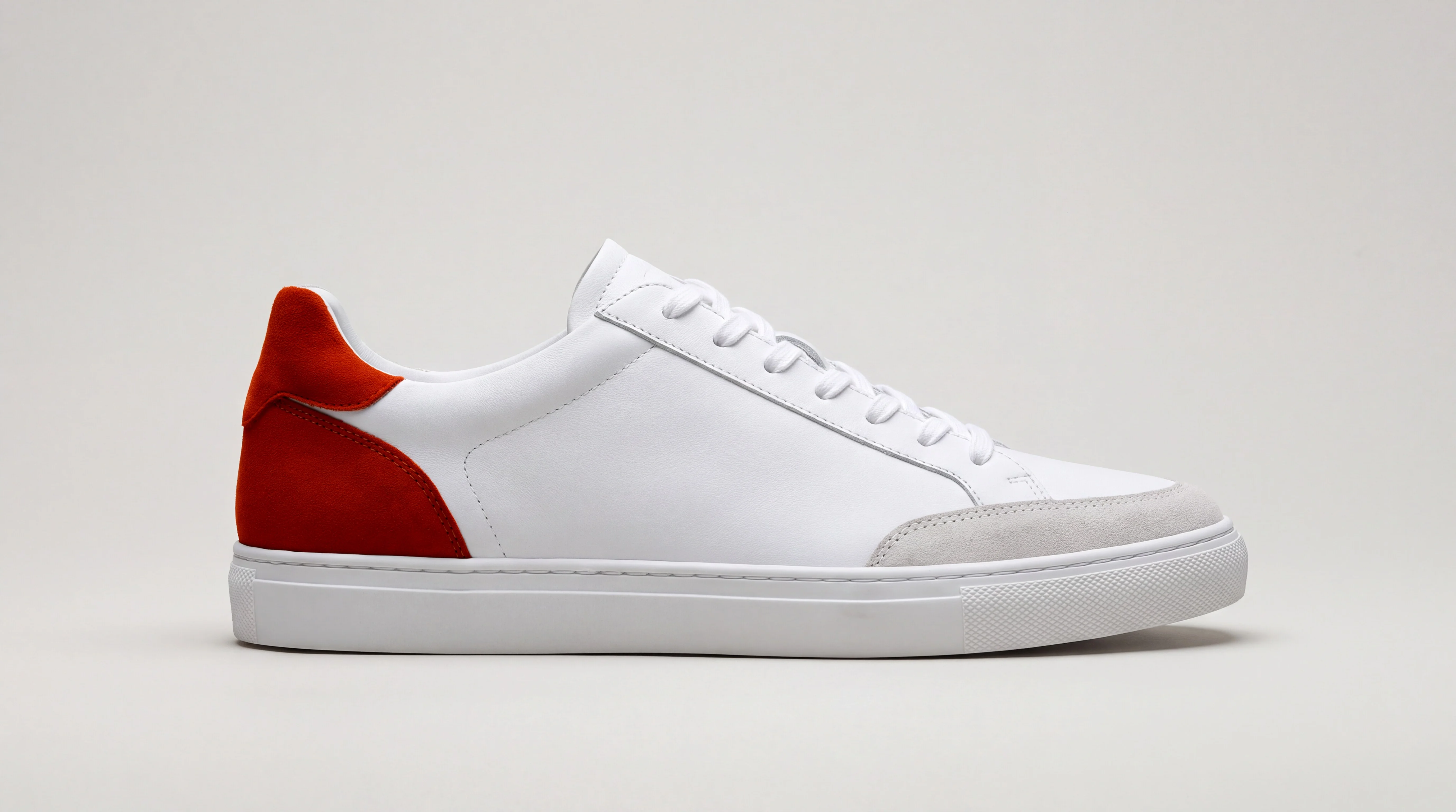 The same sneaker with the heel panel in burnt orange suede