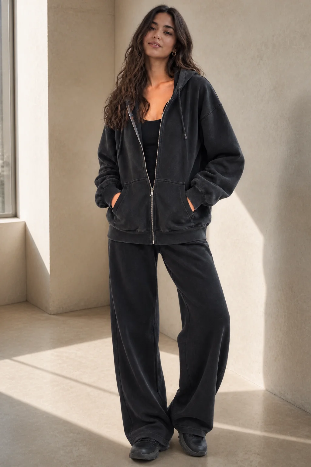 Model wearing a charcoal fleece zip-up hoodie
