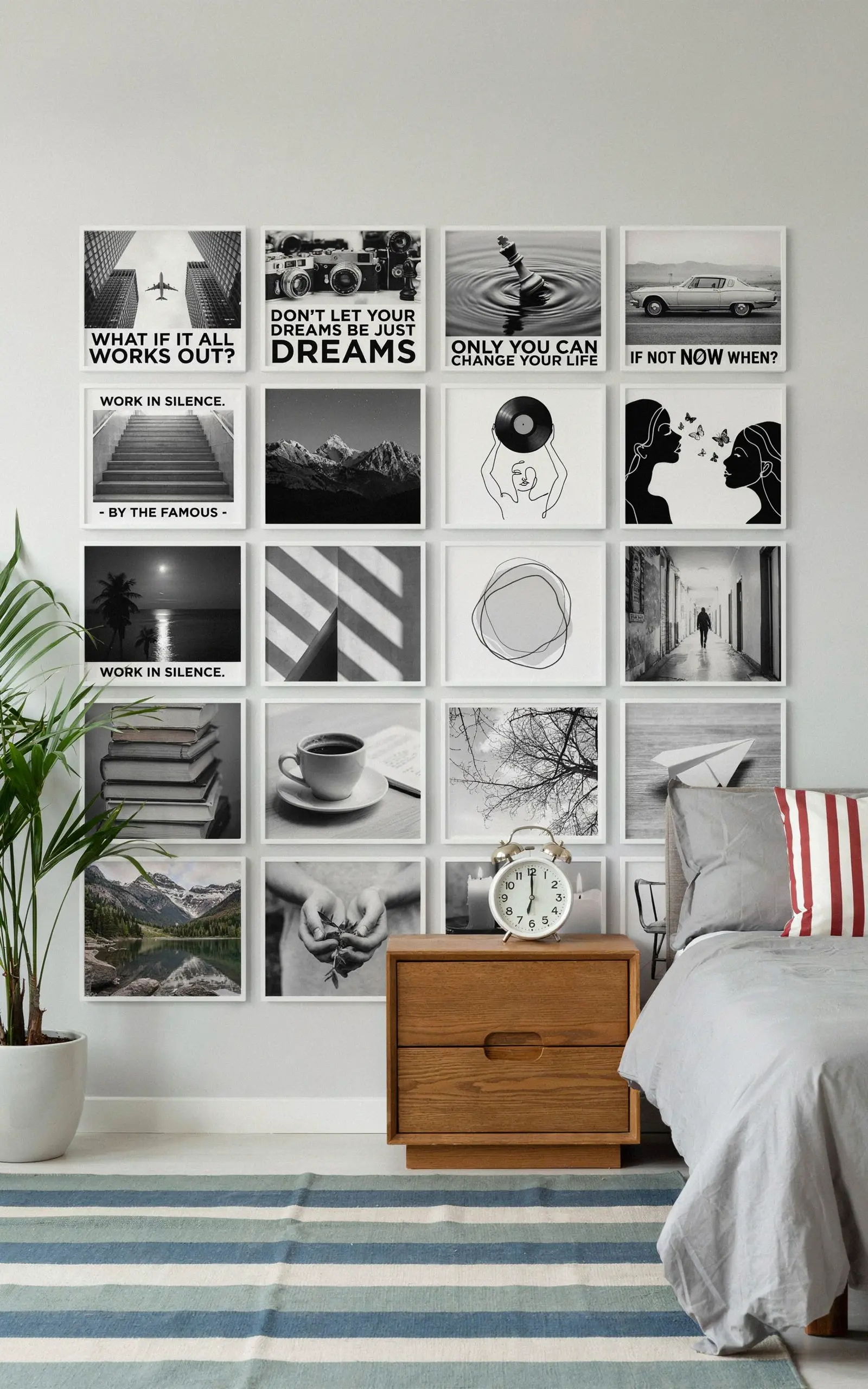 A recreated modern bedroom with framed black and white wall art panels, a wooden nightstand, an alarm clock, a potted plant, gray bedding, and a striped rug.