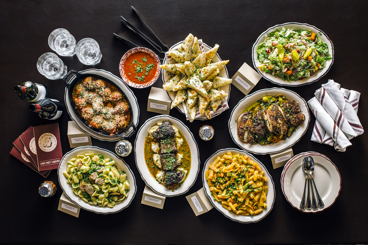 overhead photo of a variety of pasta, salads and breads