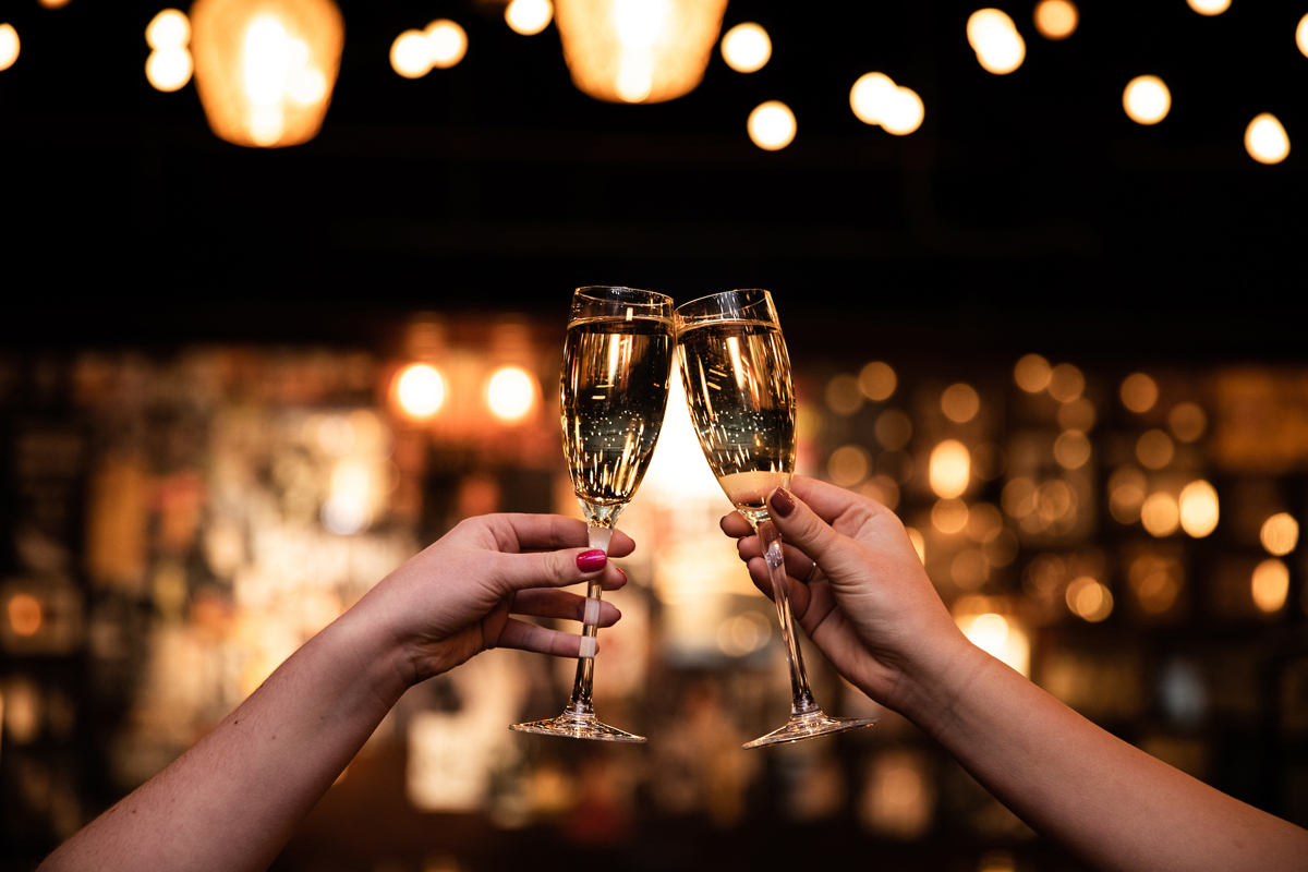 two champagne classes coming together in a toast