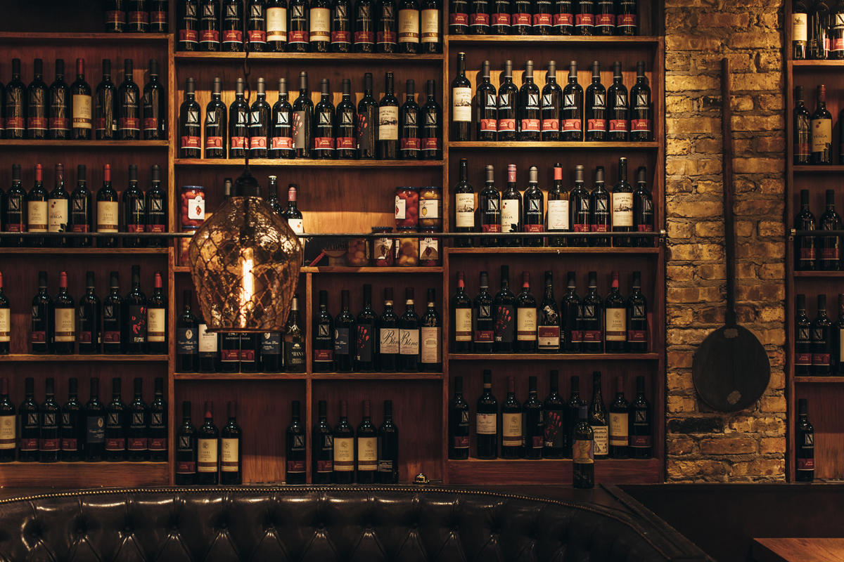 wall of shelves filled with Italian wines